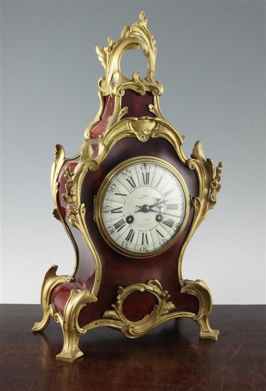 A Louis XVI style tortoiseshell and ormolu mantel clock, 19in.